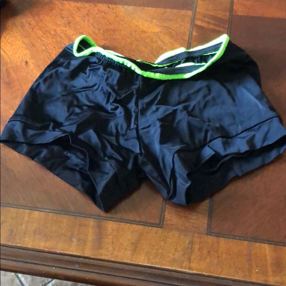 Black dance shorts with green waist lining
